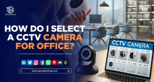A modern office with a visible CCTV camera mounted on the ceiling, overlooking desks and workstations.