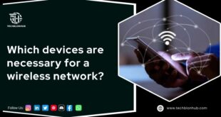 Hexagon-framed image with a black background. Left side: bold white text reads 'Which devices are necessary for a wireless network?' with a Techblonhub logo above and social media icons for Instagram, LinkedIn, Twitter, YouTube, Pinterest, Discord, Facebook, and WhatsApp below, followed by 'Follow Us:' in white. Right side: close-up of a person holding a smartphone with curved lines, dots, and a Wi-Fi icon, symbolizing a wireless network connection.